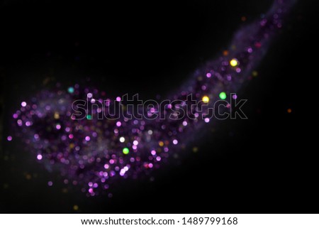 Defocused Purple Glitter on Black Background