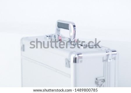 The aluminum iron suitcase with locks on a white background