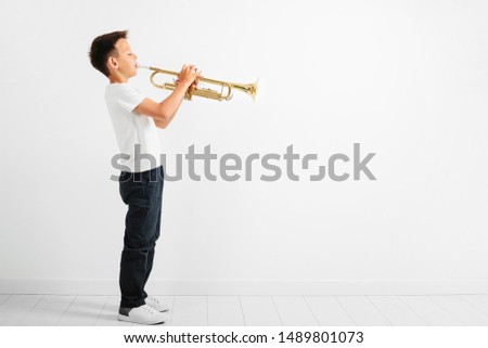 child playing trumpet on white background