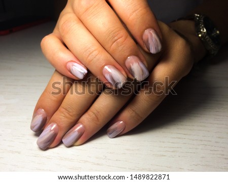 Nails care. Woman hands with  manicure on dark background. Closeup photo. Healthcare. Spa