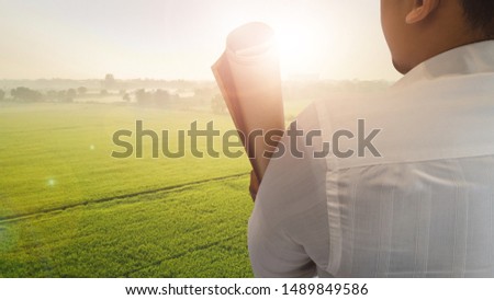 Businessman cross one's arm with cornfield concept with copy space for text.vision idea