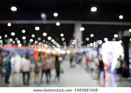 Blurred images of trade fairs in the big hall. image of people walking on a trade fair exhibition or expo where business people show innovation activity and present products in a big hall. Royalty-Free Stock Photo #1489887608