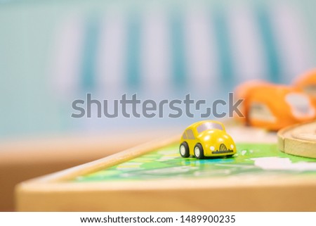Yellow car model-Traffic road sigh toy, Play set Educational toys for preschool indoor playground (selective focus)
