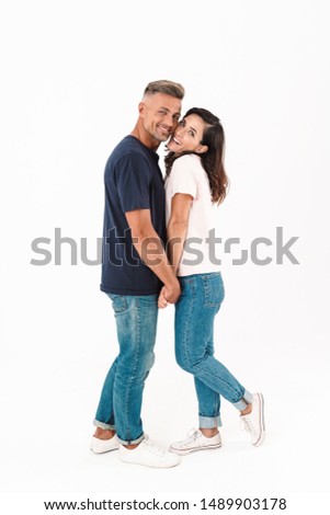Photo of a smiling cheerful adult loving couple isolated over white wall background.