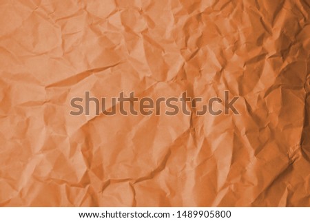 Orange color creased paper tissue background texture.