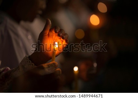 The yellow candle that was going to be quenched because of the wind blowing And there is a hand that protects against the wind in the picture, there is a niose.