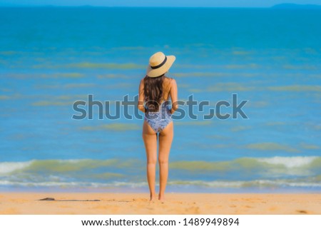 Portrait beautiful young asian woman happy smile relax on the tropical beach sea ocean for leisure travel in holiday vacation