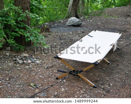 Camp cot placed in a Japanese campsite Royalty-Free Stock Photo #1489999244