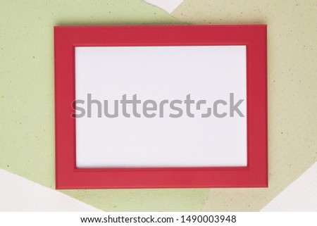 White frame with red border on paper background