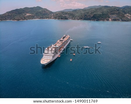Aerial view of the large cruise liner near the tropical island in the Andaman sea; recreation concept.