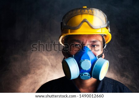 Gas mask. Respirator cartridge. Man in factory with backdrop - close up Royalty-Free Stock Photo #1490012660
