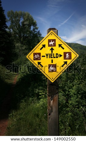 Sign "Yield" on mountain trail