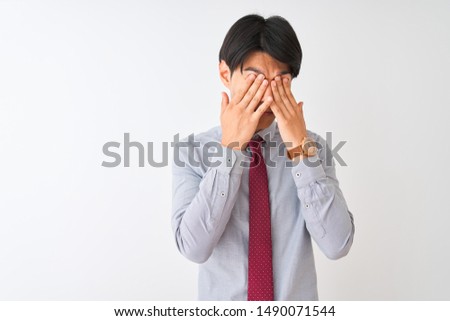 Chinese businessman wearing elegant tie standing over isolated white background rubbing eyes for fatigue and headache, sleepy and tired expression. Vision problem