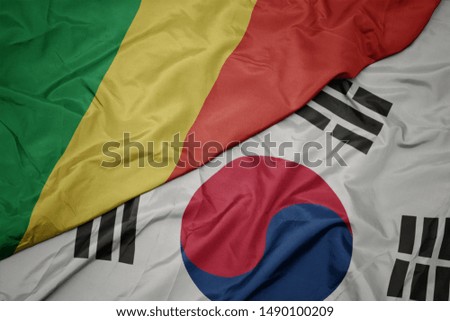 waving colorful flag of south korea and national flag of republic of the congo. macro