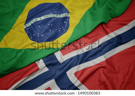 waving colorful flag of norway and national flag of brazil. macro
