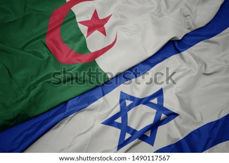 waving colorful flag of israel and national flag of algeria. macro