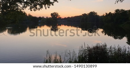 Colorful sunset at the river. Summer evening