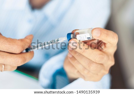 Pile of medical syringes and bottle of insulin for diabetes in woman hand Royalty-Free Stock Photo #1490135939