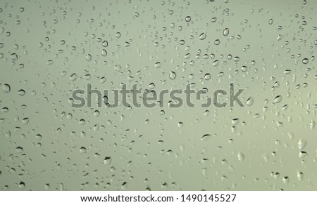 poor vision rain drops on car glass in rainy days.rain drop on window. motion blur effect.                             