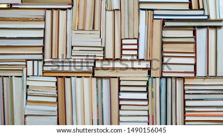 Many Books Piles. Hardback books on wooden table. Books stack texture and background. Back to school. Copy space.