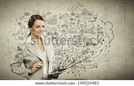 Image of young businesswoman holding ipad against sketch background
