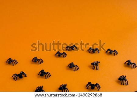 Halloween background. Spiders on an orange background. Place for text.