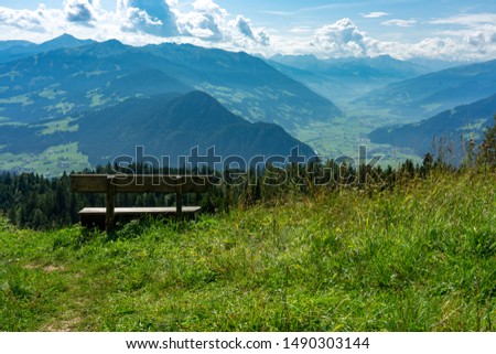 bench for resting while hiking and enjoying the green tyrol alm alps nature landscape in Austria