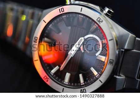 Luxury quartz watch with analog hands and a digital display and a solar battery, tachometer. Royalty-Free Stock Photo #1490327888