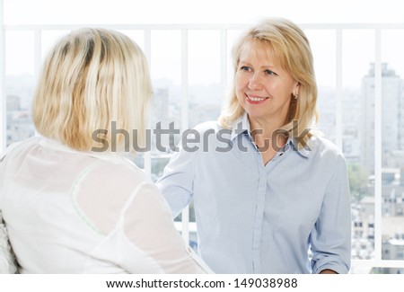 two mature women talking 