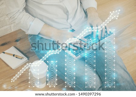 Double exposure of man's hands writing notes of stock market with forex graph background. Concept of research and trading.