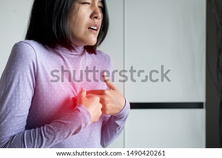 Asian woman having or symptomatic reflux acids,Gastroesophageal reflux disease,Because the esophageal sphincter that separates the esophagus and stomach dysfunction Royalty-Free Stock Photo #1490420261