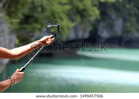 Travelers using Mobile phone and cameras take picture of mountains and lakes , Nature background.