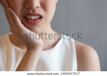 woman with toothache; sick asian woman suffering from toothache, tooth decay, tooth sensitivity, cavity, dental care concept; young adult asian woman model Royalty-Free Stock Photo #1490457917