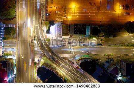 A vertical top down view over the intersection of Fuhe Bridge & East Huanhe Expressway in the nighttime, with light trails of cars dashing on the roads, in Yonghe District, New Taipei City, Taiwan