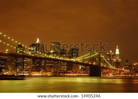 Evening view of the Brooklyn Bridge with Waterfall under and NYC skyline behind