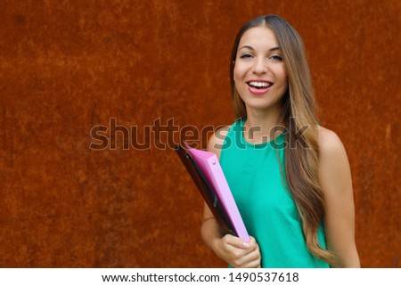 Happy confident young business woman looking at camera outdoor on rush background. Copy space.