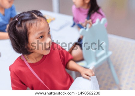 Asian elementary school girl is studying in the classroom.