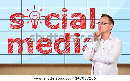 thinking businessman in office and  social media on plasma wall