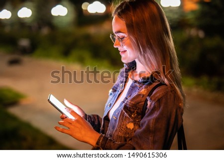 woman use mobile phone in city at night