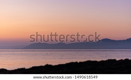Morning sea with mountains in orange sunrise, seascape, background image