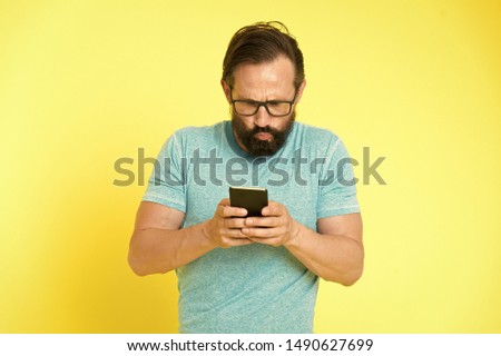 Hipster puzzled use smartphone. Man inexperienced user of modern smartphone. Stay in touch with smartphone. Join online community. User friendly concept. Man puzzled mobile phone opportunities. Royalty-Free Stock Photo #1490627699