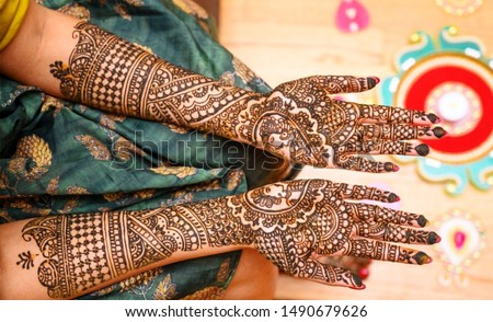 Indian bride showing hands mehndi design Royalty-Free Stock Photo #1490679626