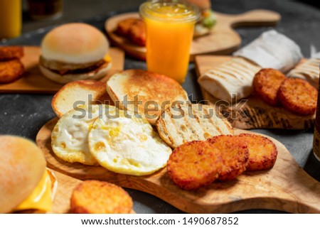 meat burger with chess and and juice and soda on the table with eggs  
