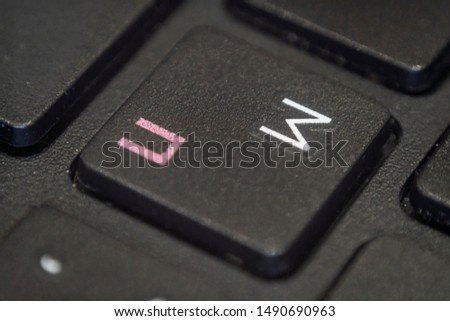 Extreme macro of the letter M on a laptop keyboard