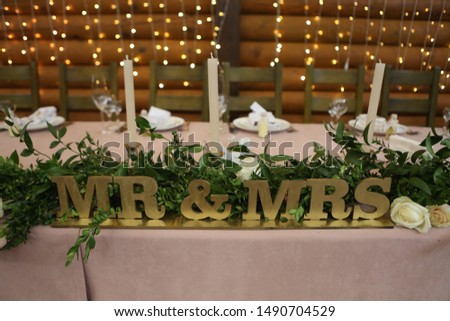 festive decor of a banquet hall with garlands of gold and floral design in a rustic style