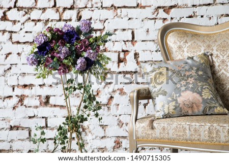 White interior of studio with white and pink flowers for photo shooting.