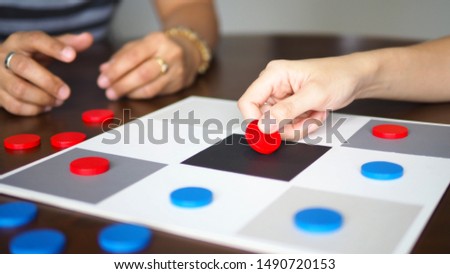 people playing tic tac toe board game strategy on wooden table top selected focus