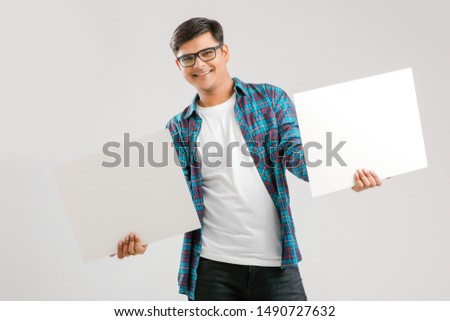  Indian/Asian Young Man showing blank signboard on White background