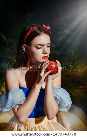 Fairy tale princess with poisoned apple in the magic wood 