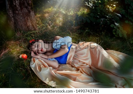 Fairy tale princess with poisoned apple in the magic wood  Royalty-Free Stock Photo #1490743781